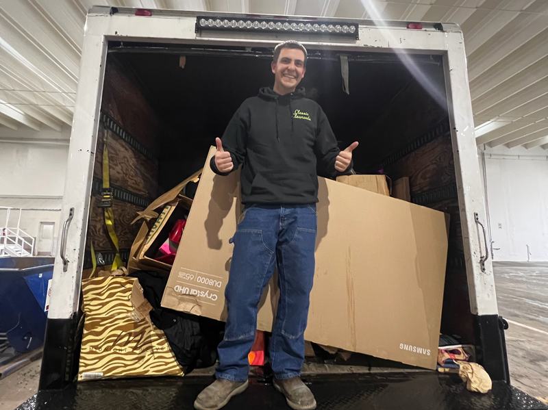 Classic Cleanouts crew member giving a thumbs up from a box truck loaded during an estate cleanout