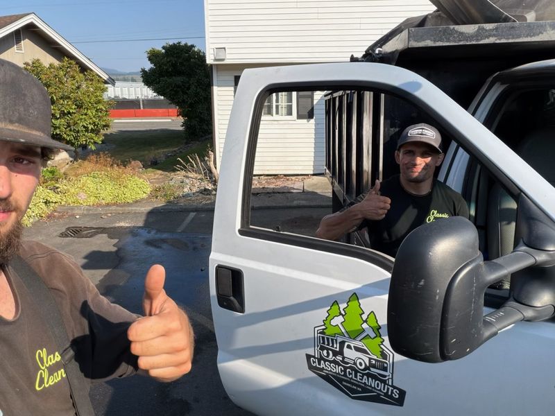 Classic Cleanouts crew giving a thumbs up beside the company truck