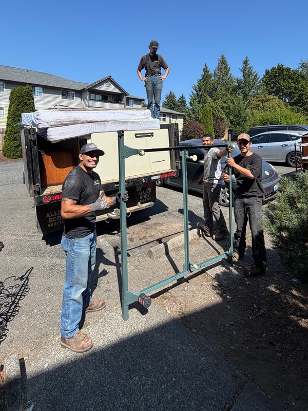 Classic Cleanouts crew loading furniture and mattresses into the truck for a junk removal job